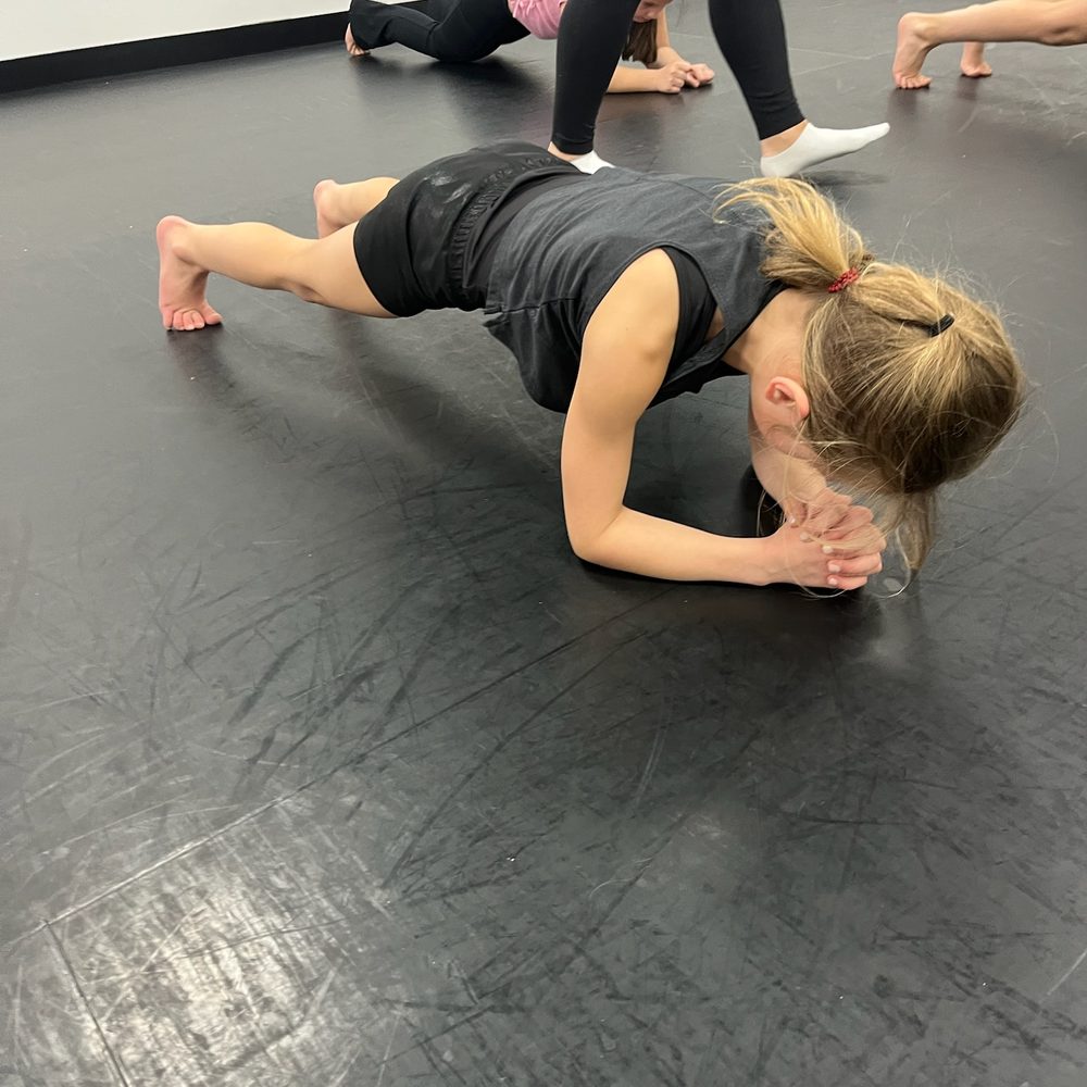 Dancers holding planks during conditioning
